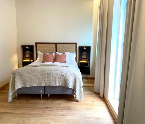 a bedroom with a bed with two pillows on it at Fritiden Hotell & Kongress in Ystad