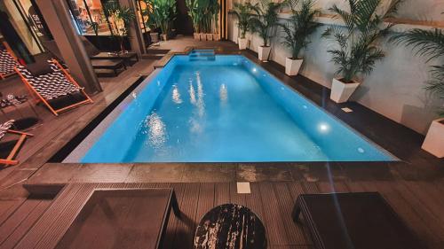 an overhead view of a swimming pool in a building at Hotel Ordinary Bangkok in Bangkok