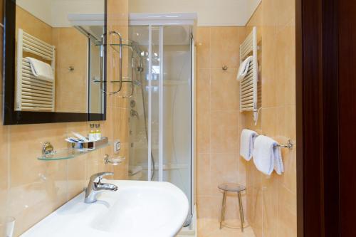 a bathroom with a sink and a shower at Hotel Puccini in Montecatini Terme