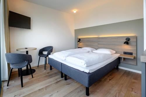 Ένα ή περισσότερα κρεβάτια σε δωμάτιο στο Go Hotel City Apartments