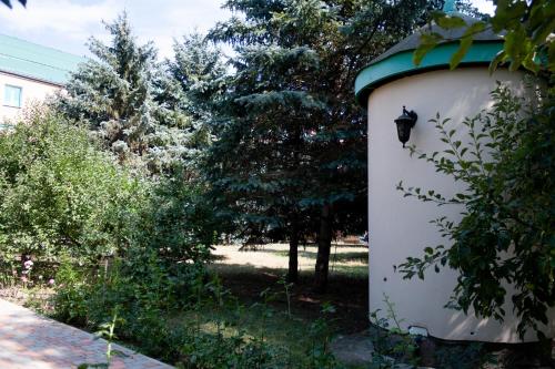 a white building with a green roof next to trees at Fortetsya "Стабільне електропостачання!" in Umanʼ