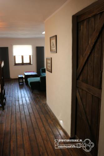 a living room with a sliding door and a couch at Gotyk na dotyk z tarasem na dachu in Toruń
