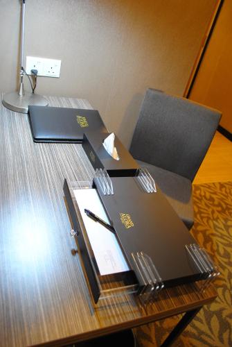 a desk with a laptop on top of a table at Grand Alora Hotel in Alor Setar