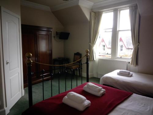 Ένα ή περισσότερα κρεβάτια σε δωμάτιο στο Dunallan Guest House