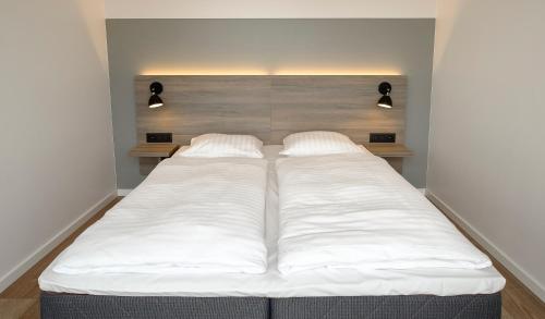 Ένα ή περισσότερα κρεβάτια σε δωμάτιο στο Go Hotel City Apartments