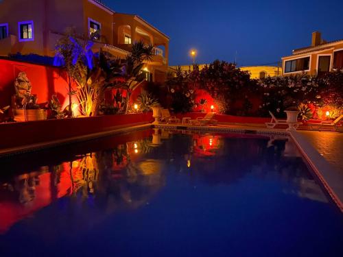 a swimming pool in a yard at night at Casa Concha - Peaceful and Relaxing in Lagos