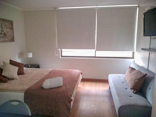 Tempat tidur dalam kamar di Apartamentos Costanera Centre