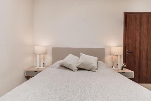 a bedroom with a large bed with two night stands at Casaelia in Zakynthos Town