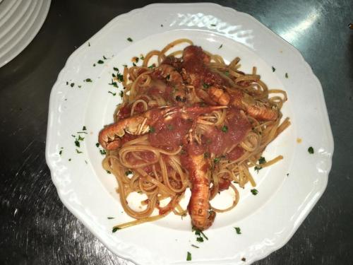 a plate of pasta with a lobster on it at Hotel PINO LORICATO in Castelluccio Inferiore