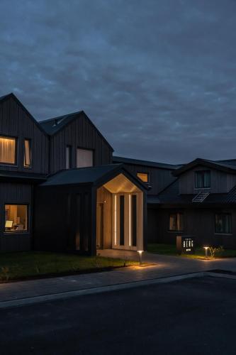 a house at night with lights on the street at Hotel Berg by Keflavik Airport in Keflavík