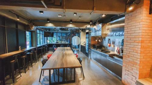 a dining room with a wooden table in a restaurant at Hotel Ordinary Bangkok in Bangkok