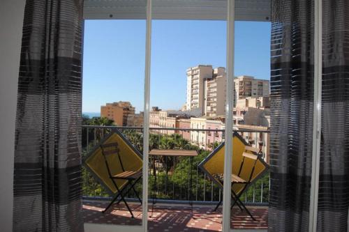 a view of a city from a balcony with two chairs at Eloisa Guest House in Sciacca