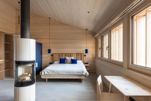 a bedroom with a bed and a fireplace at Fuchsegg Eco Lodge in Egg