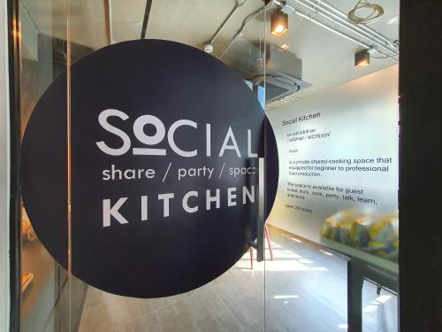 a sign that reads social share party service k kitchen at Hotel Ordinary Bangkok in Bangkok