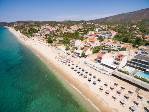 an aerial view of a beach with umbrellas and chairs at Xenia Suites in Limenaria