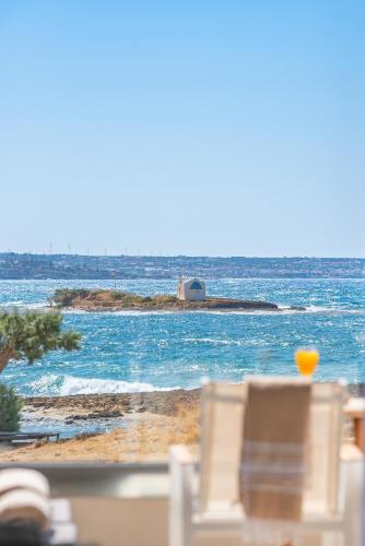 a view of the ocean from a beach with chairs at Pyrgos Blue in Malia