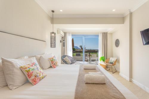 a living room with a large white couch with pillows at Pyrgos Blue in Malia