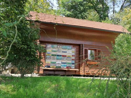 a log cabin with a sign in the window at Apartments Bukor with seasonal pool in Lukovica pri Domžalah