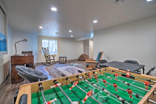 a living room with a pool table in the middle at Lake House with Hot Tub - 1 Mi to Surf n Slide in Moses Lake