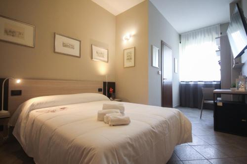 Postel nebo postele na pokoji v ubytování Hotel Gran Torino