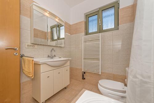 a bathroom with a sink and a toilet at Modern House with Sea View in Chania Town