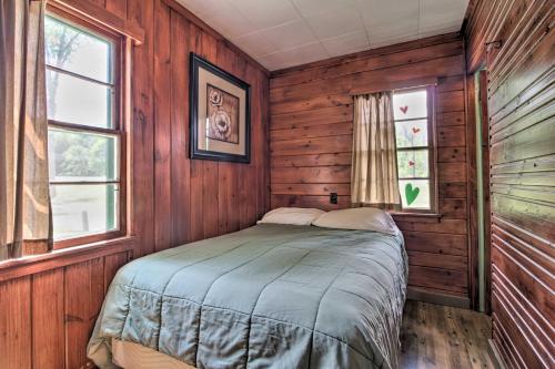a bedroom with wooden walls and a bed in a room at Pet-Friendly Beachfront Dent Cabin w/ Grill! in Dent