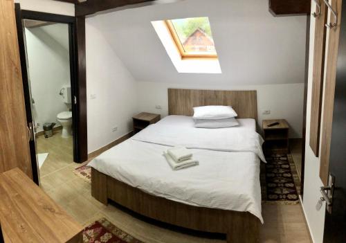 En eller flere senge i et værelse på Vila FAN Confort