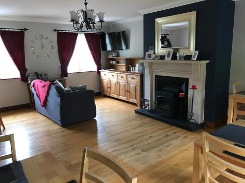 a living room with a couch and a fireplace at Grove Lodge B&B in Monaghan