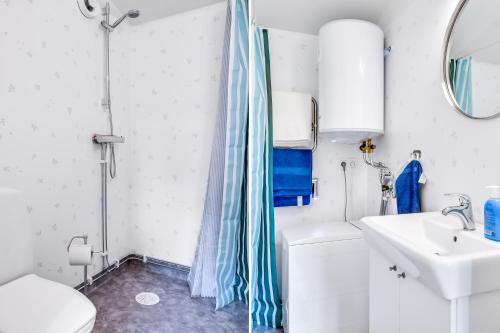 a bathroom with a shower curtain and a sink at Cosy stay in southern Malmo in Malmö