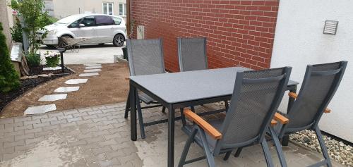 a black table and chairs sitting on a patio at Wellness Apartmány EMPORIO in Loštice