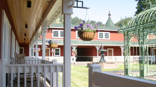 a porch of a house with flowers in a basket at Beaver Valley Lodge in Leavenworth