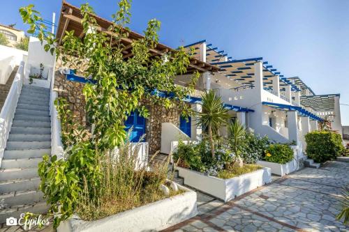 a building with stairs and plants in front of it at Lina studios in Kalymnos