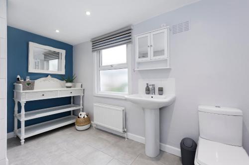 a bathroom with a sink and a toilet at Pepperpot Cottage in Whitstable