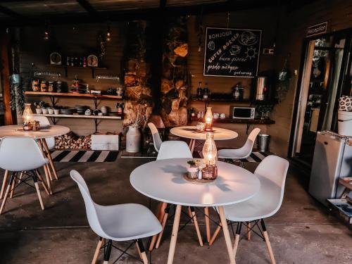 a group of tables and chairs in a restaurant at Rustique in Graskop