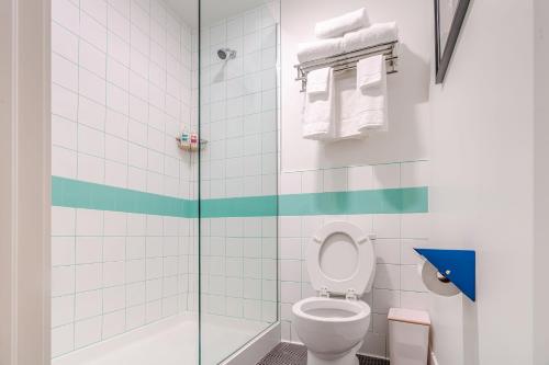 a bathroom with a toilet and a shower at Classen Inn in Oklahoma City