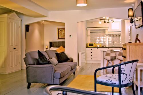 a living room with a couch and a kitchen at City Studios in Ely