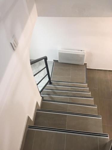 a set of stairs in a room with a box at COSY PUTEAUX QUAI DION BOUTOn in Puteaux