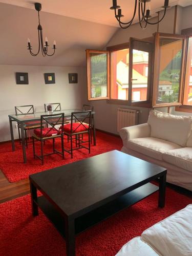 a living room with a coffee table and a couch at Apto Rio Asón, desconexión total con Piscina y vistas espectaculares in Gibaja