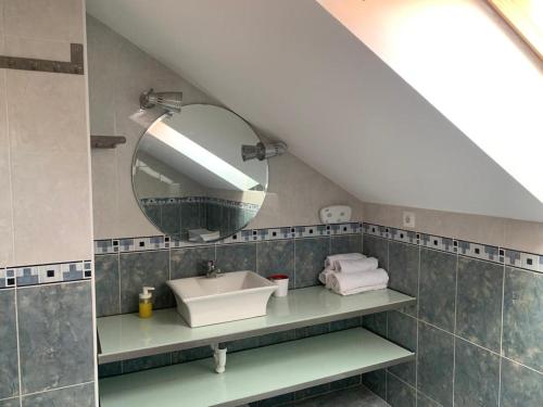 a bathroom with a sink and a mirror at Apto Rio Asón, desconexión total con Piscina y vistas espectaculares in Gibaja
