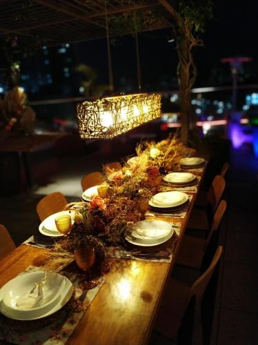 a long table with white plates and flowers on it at ibis Jundiai Shopping in Jundiaí