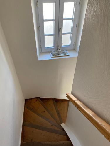 a staircase with a window and a wooden floor at Charmante Maison Bretonne à 2 minutes des plages in Plouescat