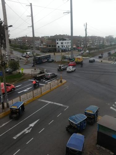 a busy street with cars and buses on a city street at Hostal Jara in Lima