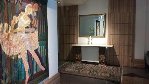 a bathroom with a sink and a mirror at Castel Plaza Hotel in Resende