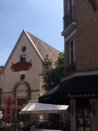 a building with a red anchor on the side of it at COSY PUTEAUX QUAI DION BOUTOn in Puteaux