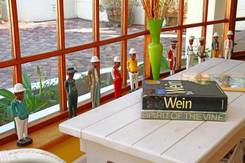 a group of toy figurines on a table next to a window at Kleinbosch Lodge in Stellenbosch
