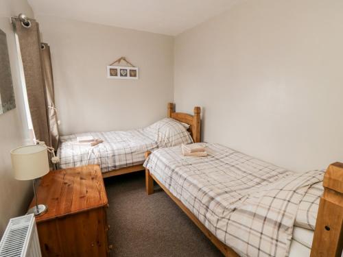 En eller flere senge i et værelse på Stable Cottage