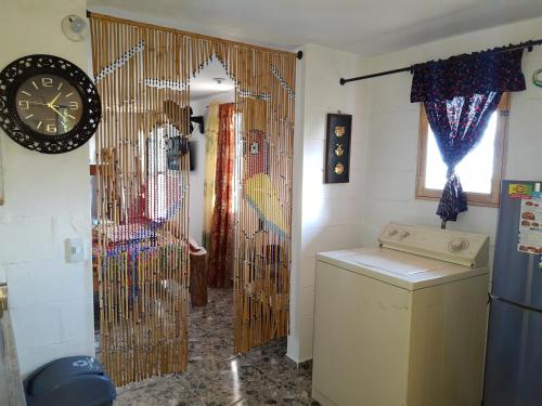 a hallway with a door with a clock on the wall at Apartamento Campestre Medellin in Medellín