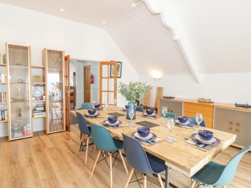 a large dining room with a long table and chairs at Saron Chapel in Llandudno