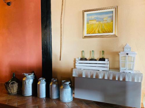 a group of vases sitting on a table in a room at Agriturismo La Perlara - Adults Only in Verona