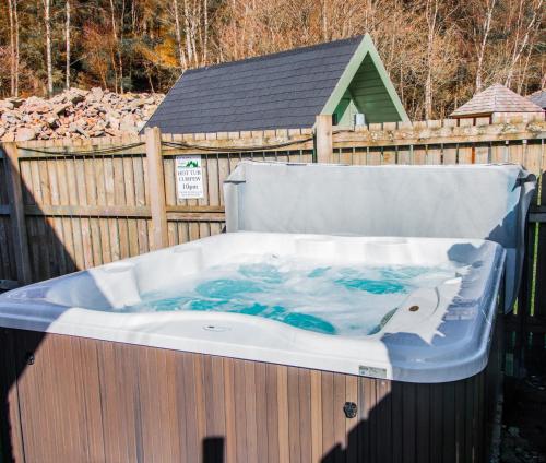 a bath tub with a whale painted on it at Balmaha Lodges and Apartments in Balmaha